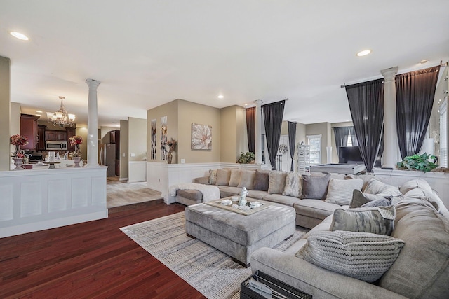 living room featuring dark wood-type flooring and a chandelier