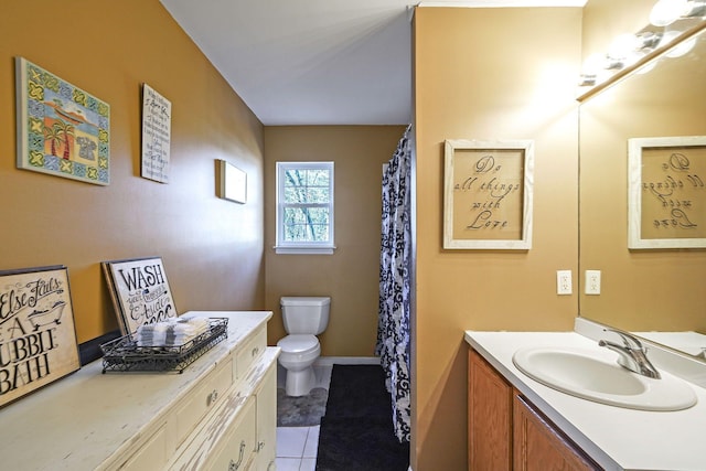 bathroom featuring tile patterned flooring, vanity, and toilet