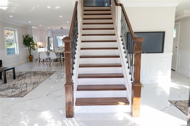 stairway featuring ornamental molding