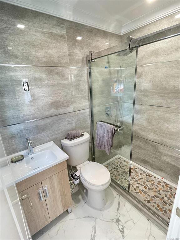 bathroom featuring vanity, toilet, an enclosed shower, and ornamental molding