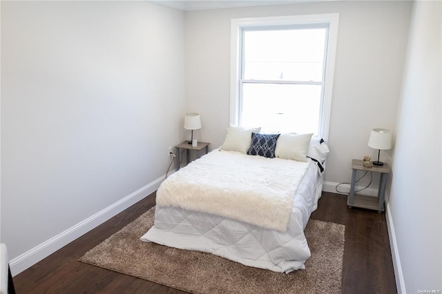 bedroom with dark hardwood / wood-style flooring