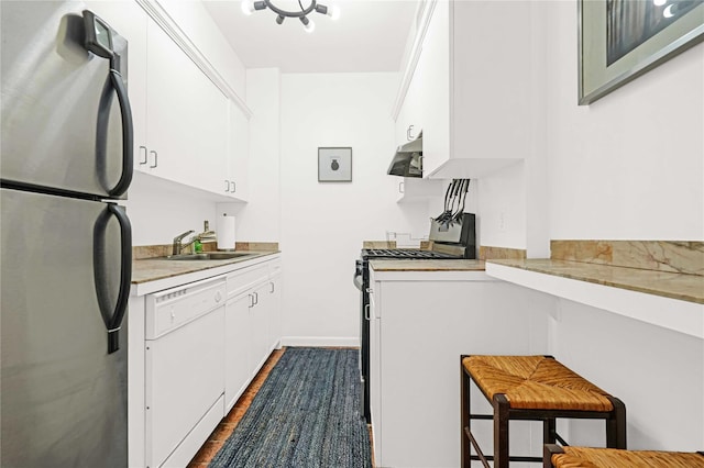 kitchen featuring white appliances, white cabinetry, dark wood-type flooring, and sink