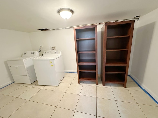 laundry room with separate washer and dryer and light tile patterned floors