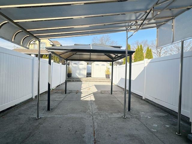 view of patio / terrace featuring a carport and a storage shed