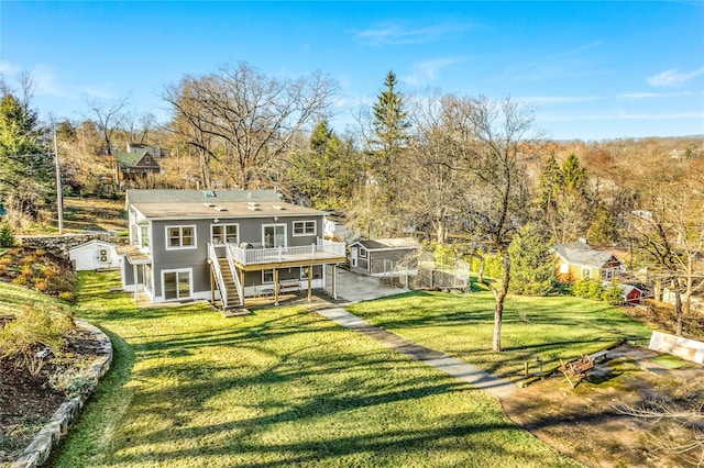 back of house with a yard and a wooden deck