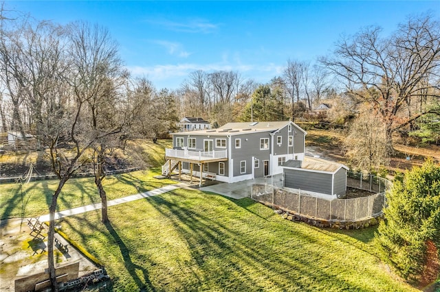 back of property featuring a lawn, a balcony, and a patio