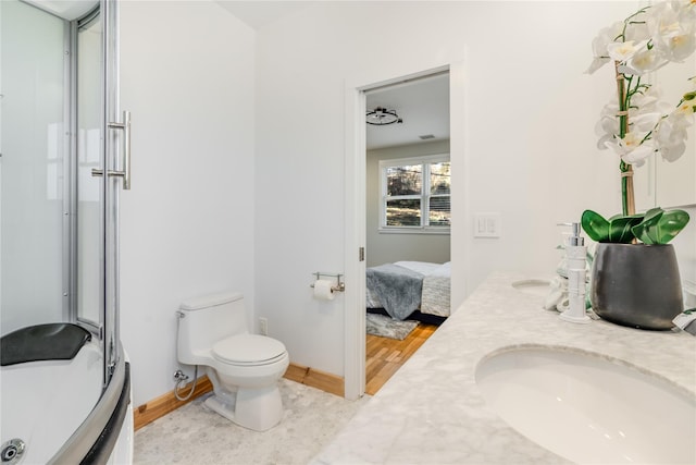 bathroom with toilet, vanity, a shower with shower door, and hardwood / wood-style flooring