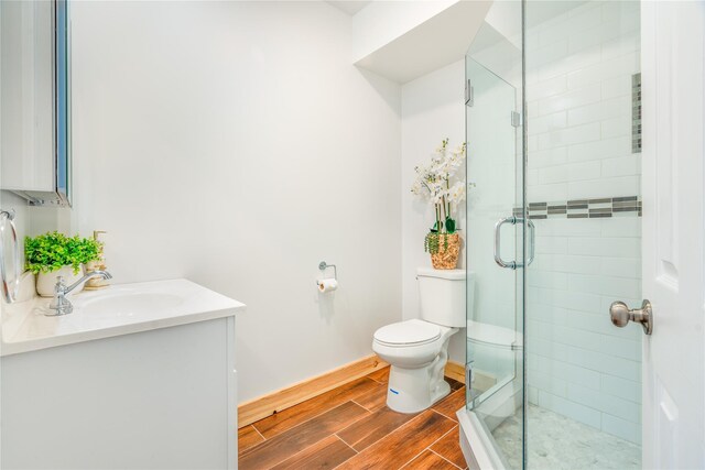 bathroom with vanity, toilet, and a shower with shower door