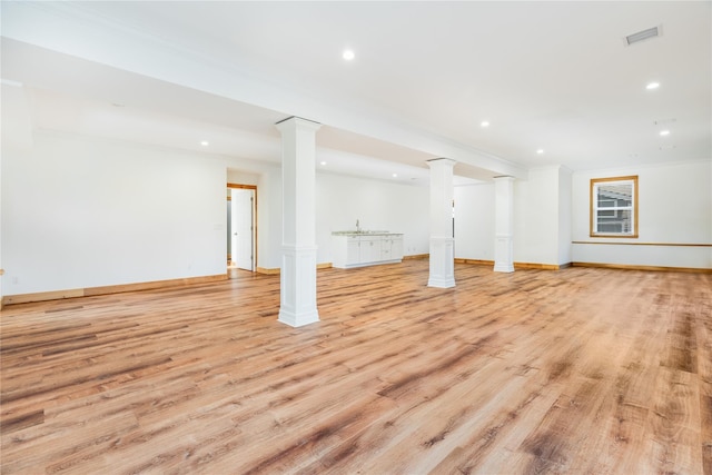 basement featuring light hardwood / wood-style floors and sink