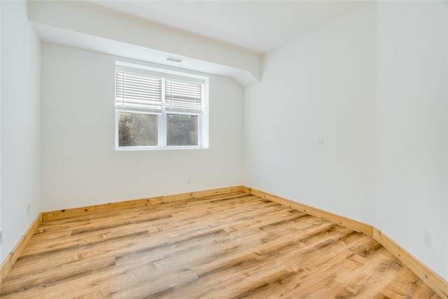 spare room with hardwood / wood-style floors