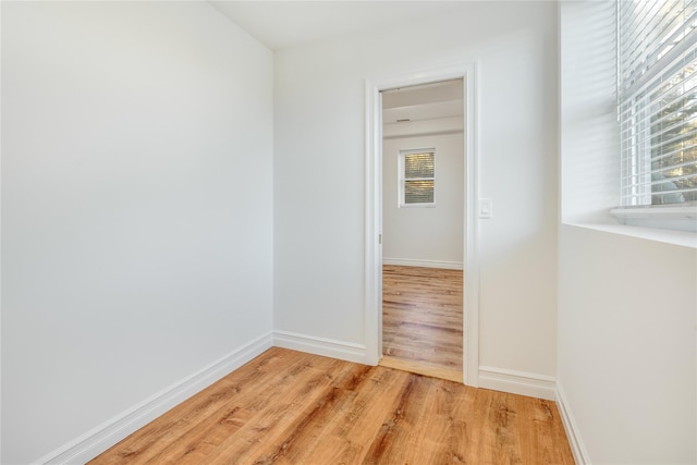 hallway with light hardwood / wood-style flooring