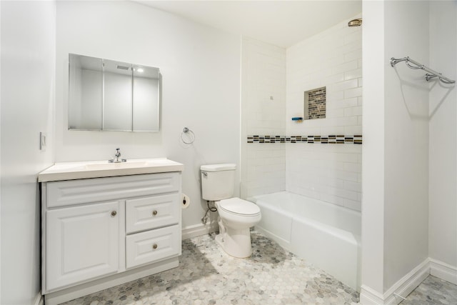 full bathroom featuring vanity, toilet, and tiled shower / bath