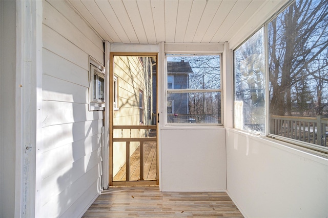 unfurnished sunroom featuring wooden ceiling