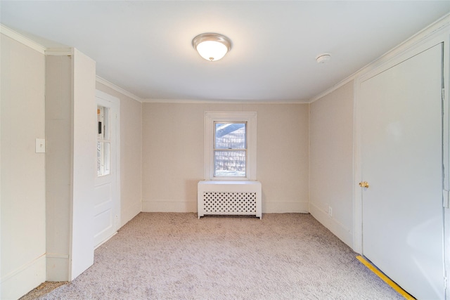 carpeted spare room featuring ornamental molding