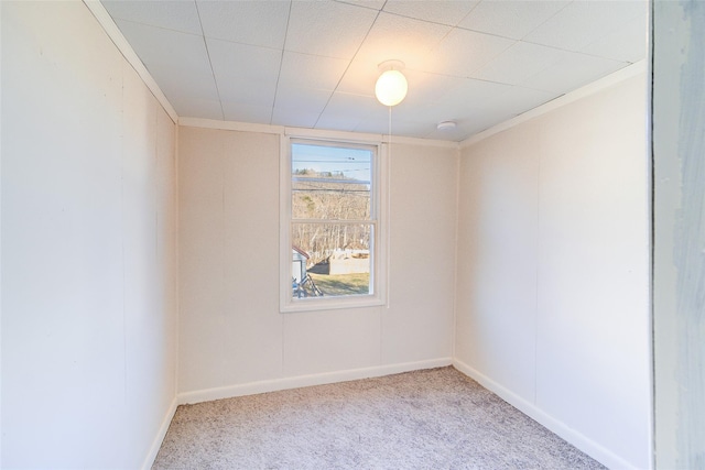 unfurnished room featuring crown molding and light carpet