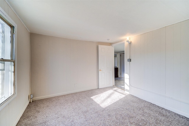 carpeted spare room featuring a wealth of natural light