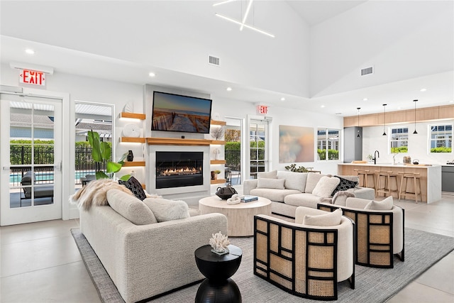 12 Depot Road 1302 (Pearl Way), Westhampton Beach, NY 11978 - living area featuring recessed lighting, a glass covered fireplace, and a high ceiling