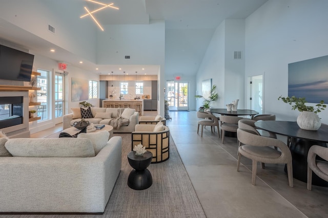 12 Depot Road 1302 (Pearl Way), Westhampton Beach, NY 11978 - living area with a towering ceiling, concrete flooring, healthy amount of natural light, recessed lighting, and a multi sided fireplace