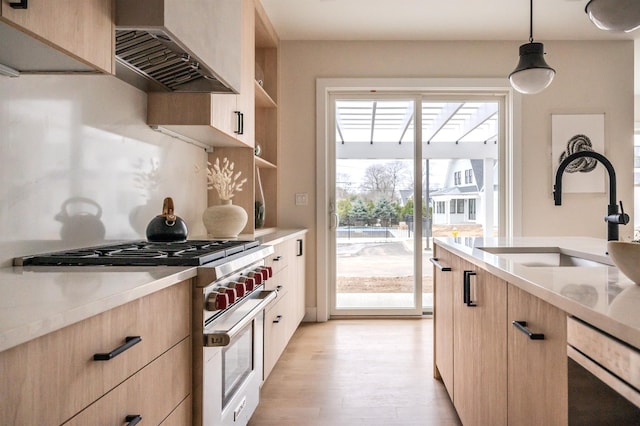12 Depot Road 1302 (Pearl Way), Westhampton Beach, NY 11978 - kitchen featuring stainless steel stove, wall chimney exhaust hood, light brown cabinetry, a sink, and light countertops