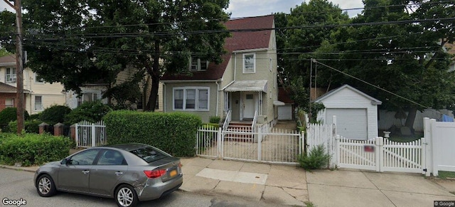 view of front facade featuring a garage and an outdoor structure