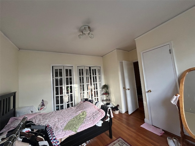 bedroom with dark wood-type flooring