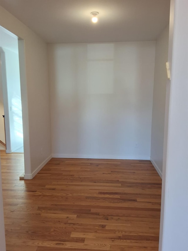 unfurnished room with hardwood / wood-style flooring