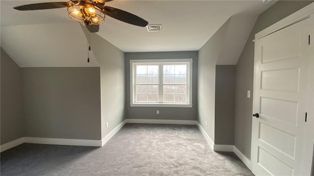 additional living space featuring ceiling fan, lofted ceiling, and light carpet