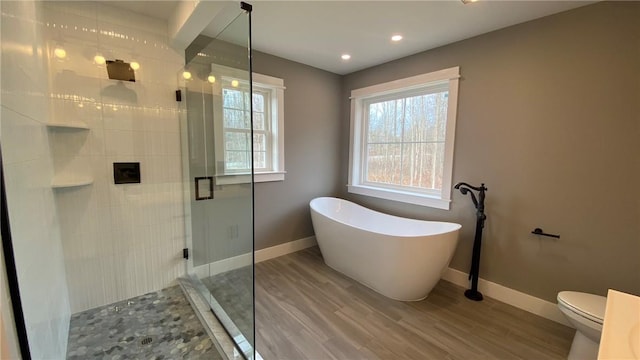 bathroom with wood-type flooring, toilet, and independent shower and bath