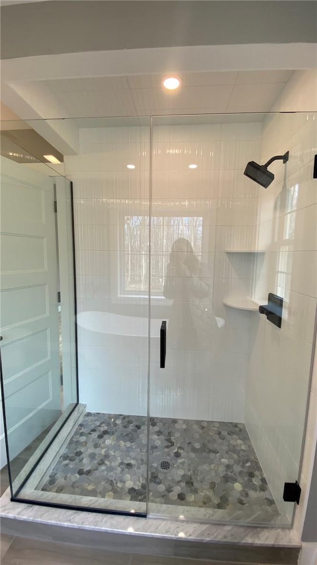 bathroom featuring a shower with shower door