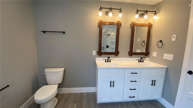 bathroom with vanity, wood-type flooring, and toilet