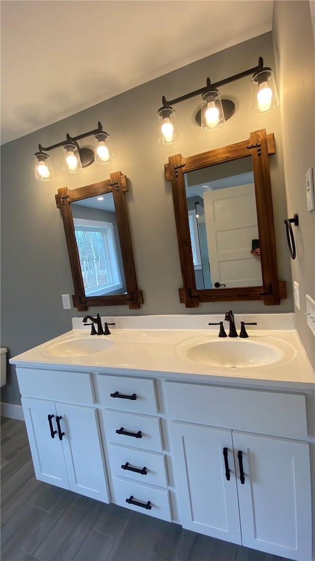 bathroom with hardwood / wood-style flooring, vanity, and toilet