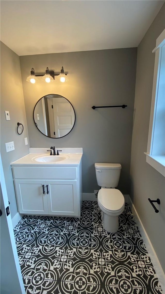 bathroom featuring tile patterned floors, vanity, and toilet