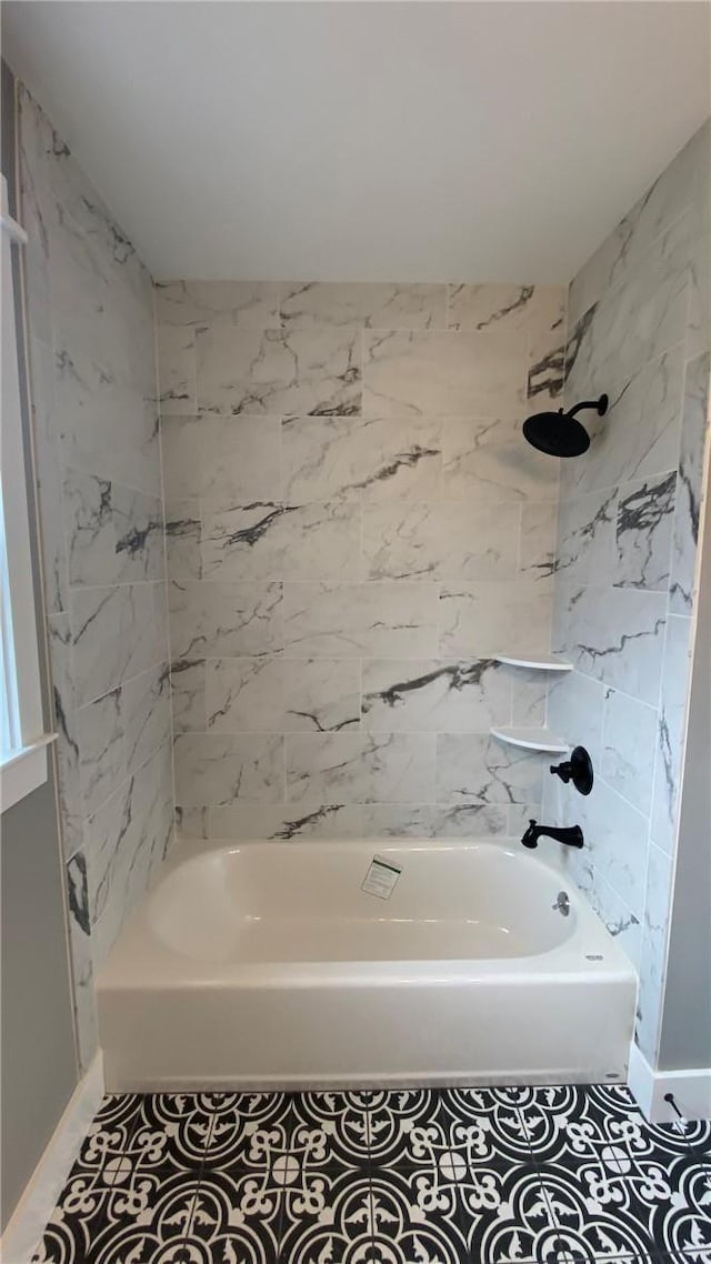 bathroom featuring tile patterned flooring and tiled shower / bath combo