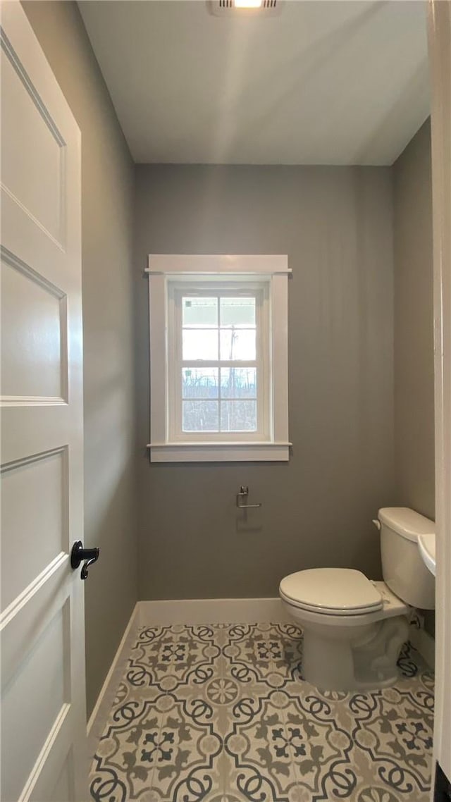 bathroom featuring tile patterned flooring and toilet