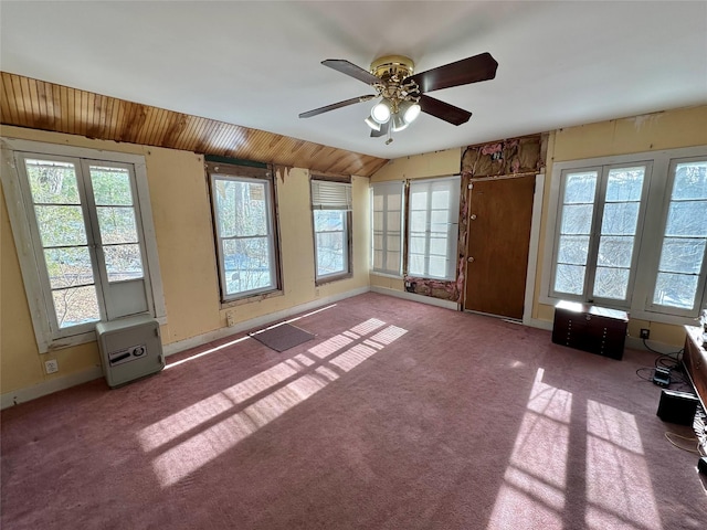 interior space with ceiling fan, lofted ceiling, and wood ceiling