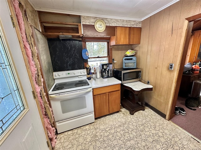 kitchen featuring crown molding, wooden walls, and white electric range