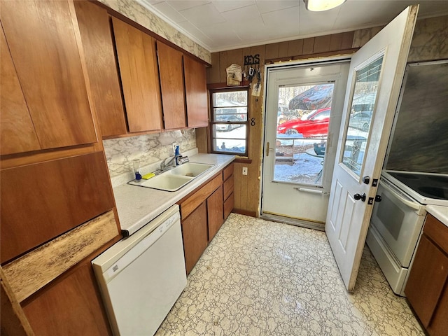 kitchen featuring dishwasher, range, and sink