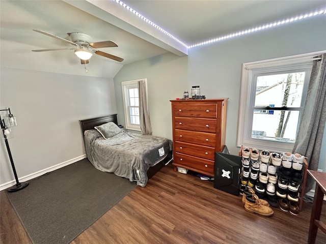 bedroom with ceiling fan, dark hardwood / wood-style flooring, and vaulted ceiling