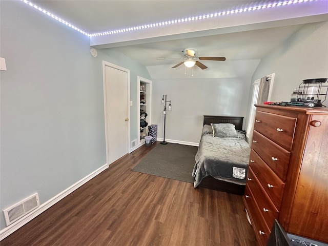 bedroom with ceiling fan, dark wood-type flooring, and vaulted ceiling