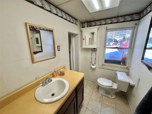 bathroom with tile patterned floors, vanity, and toilet