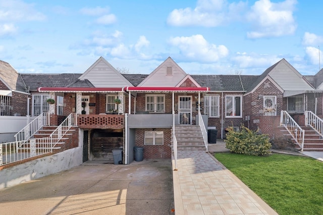 view of property featuring a front lawn and covered porch