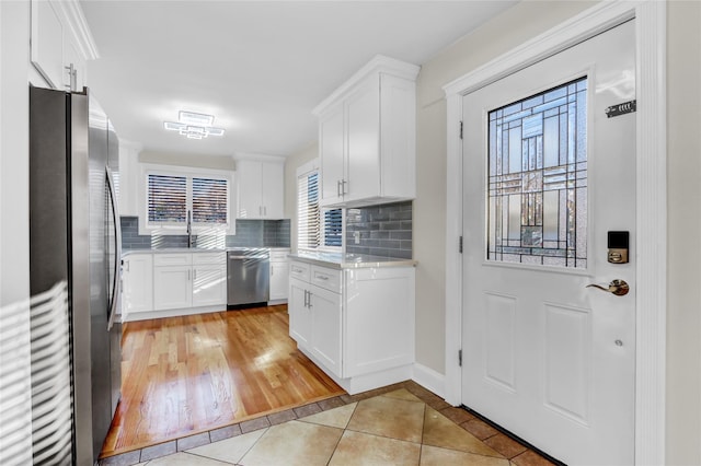 kitchen featuring white cabinets, stainless steel appliances, light hardwood / wood-style flooring, and plenty of natural light