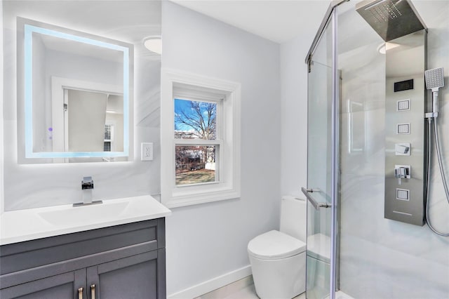 bathroom featuring walk in shower, vanity, and toilet