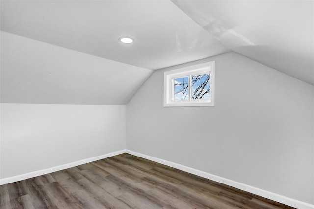 bonus room with dark hardwood / wood-style floors and lofted ceiling