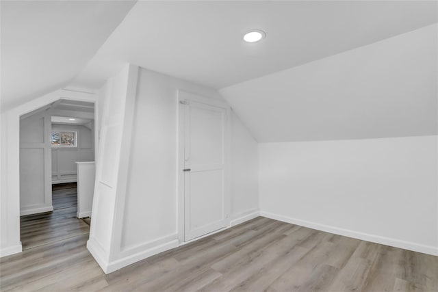 bonus room featuring light hardwood / wood-style floors and vaulted ceiling