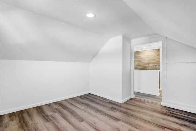 bonus room featuring light hardwood / wood-style flooring and vaulted ceiling