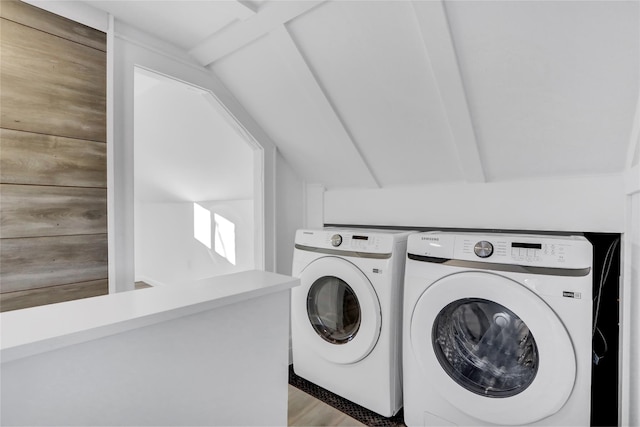 washroom with washer and dryer and wood-type flooring