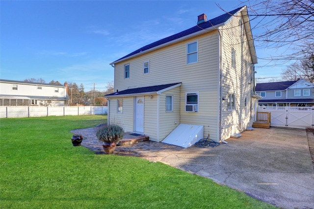 back of house featuring a yard and a patio