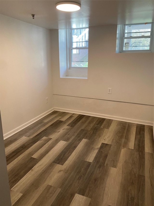 empty room with dark hardwood / wood-style flooring