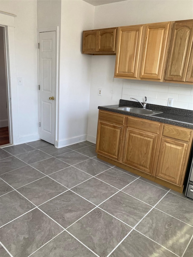 kitchen featuring tasteful backsplash and sink